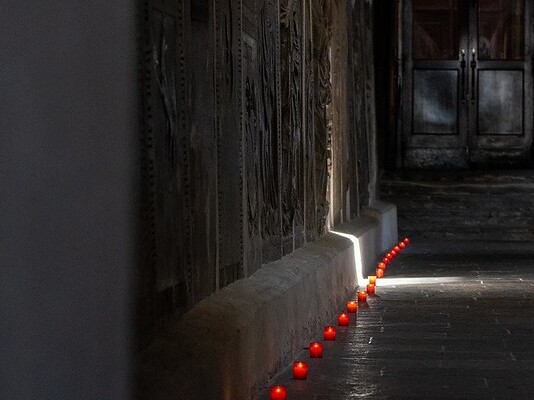 rote Lichterspur im Dunkeln entlang von Grabsteinen